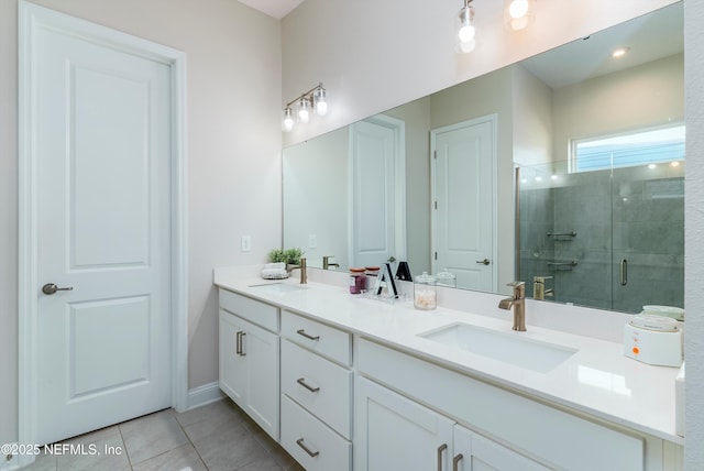 bathroom with an enclosed shower, vanity, and tile patterned floors