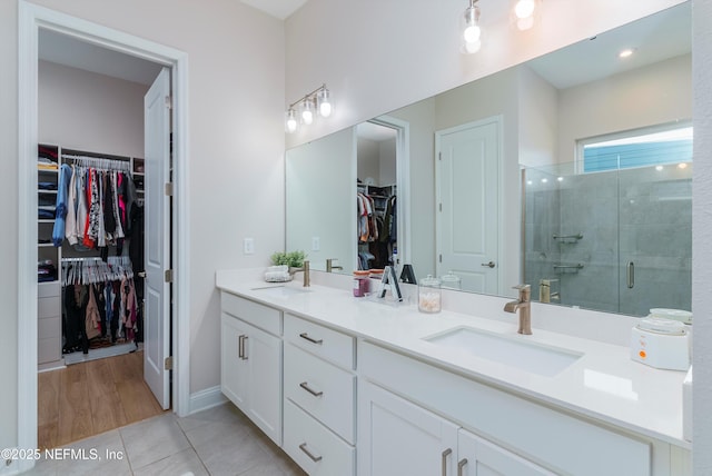 bathroom with tile patterned flooring, vanity, and a shower with shower door