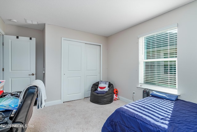 carpeted bedroom with a closet