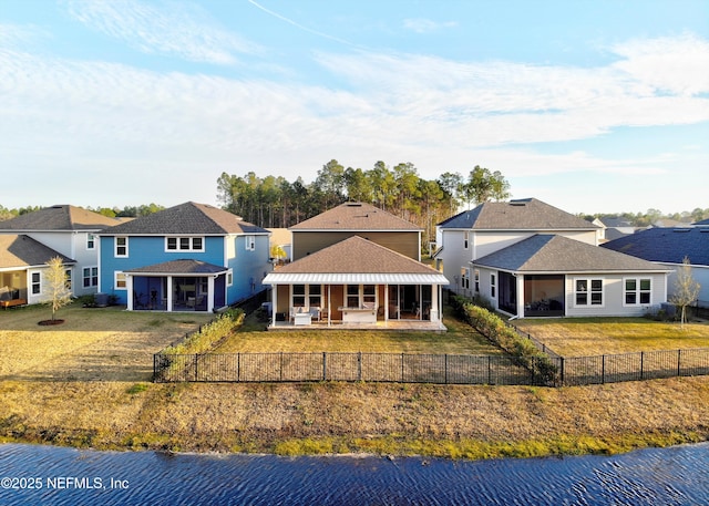 rear view of house featuring a water view