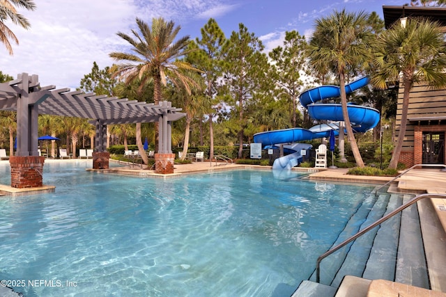 view of pool with a water slide and a pergola