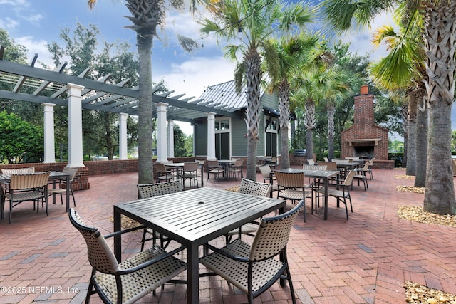 view of patio featuring an outdoor fireplace and a pergola