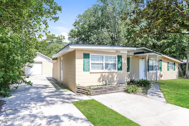 view of front of house with a garage, an outdoor structure, and a front lawn