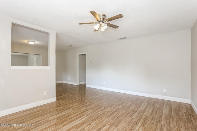 spare room featuring a textured ceiling, light hardwood / wood-style floors, and ceiling fan