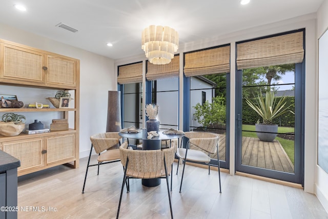 dining area featuring light wood-style floors, recessed lighting, visible vents, and a notable chandelier