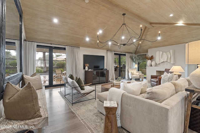 living room featuring wooden ceiling, a wealth of natural light, wood finished floors, and french doors