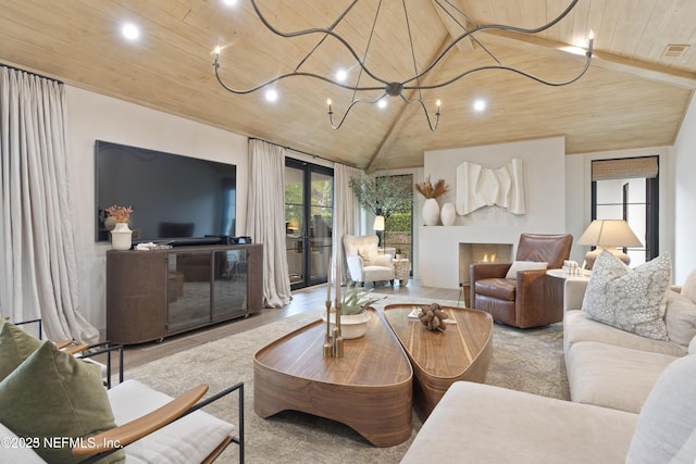 living area with a chandelier, wood ceiling, vaulted ceiling, and a lit fireplace