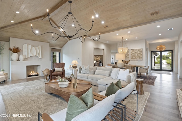 living room with visible vents, wood ceiling, beamed ceiling, light wood-style floors, and a notable chandelier