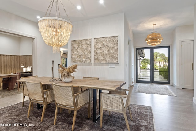 dining area featuring a chandelier, recessed lighting, french doors, and wood finished floors