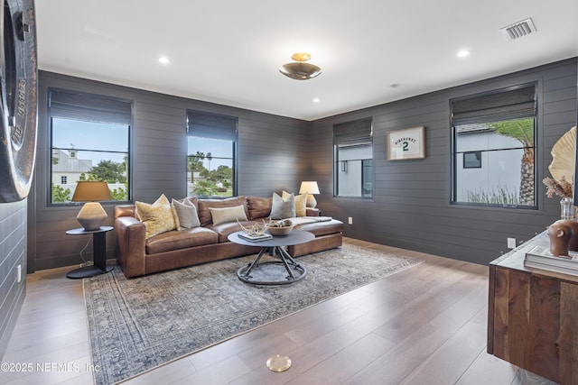 living room featuring recessed lighting, visible vents, and light wood finished floors