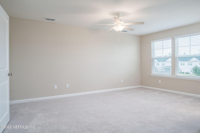 unfurnished room featuring ceiling fan and light carpet