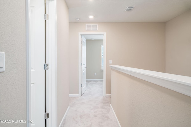 corridor with light colored carpet