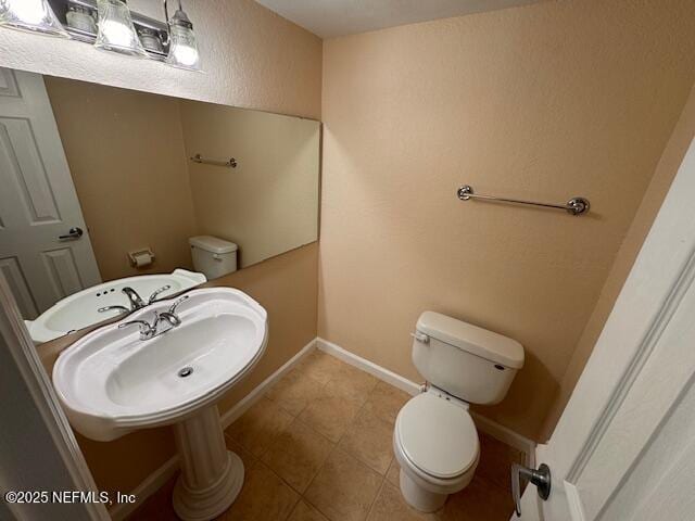 bathroom with sink, tile patterned floors, and toilet