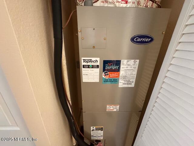 utility room featuring heating unit