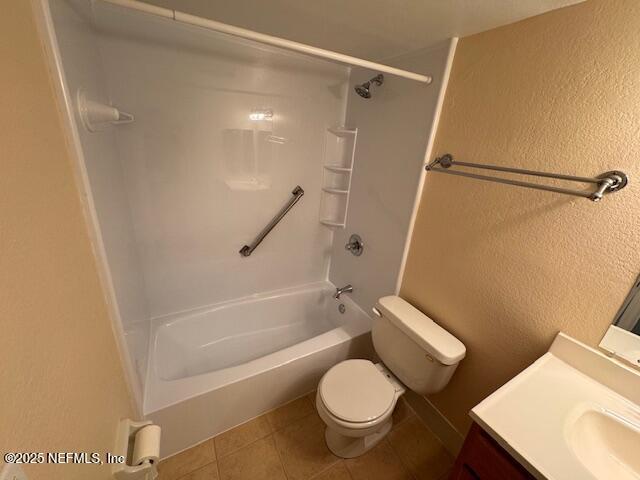 full bathroom featuring tile patterned flooring, vanity, toilet, and  shower combination