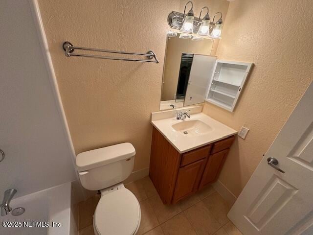 bathroom with tile patterned flooring, vanity, and toilet