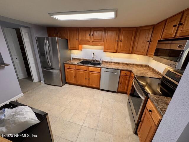 kitchen with sink and appliances with stainless steel finishes