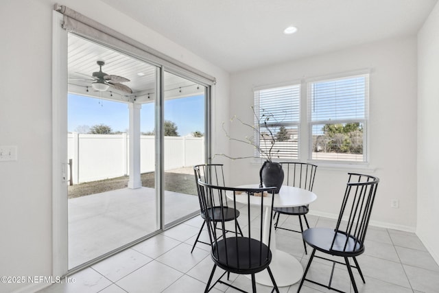 dining space featuring light tile patterned floors and ceiling fan