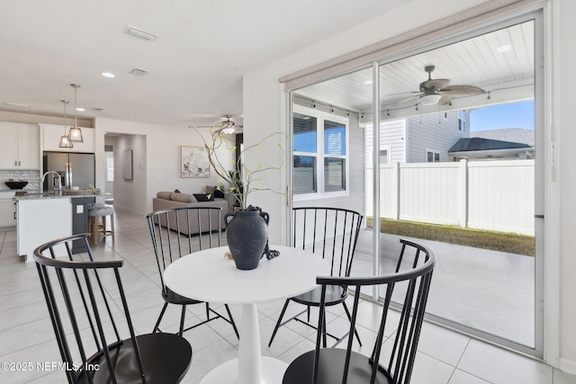 dining area featuring ceiling fan and light tile patterned floors