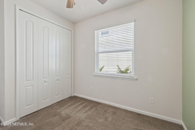 unfurnished bedroom with carpet floors, ceiling fan, and a closet