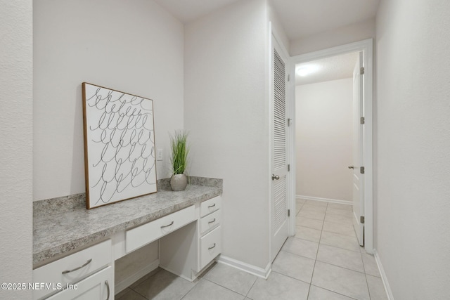 hall featuring light tile patterned flooring