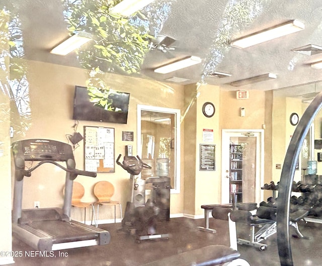 gym featuring a textured ceiling