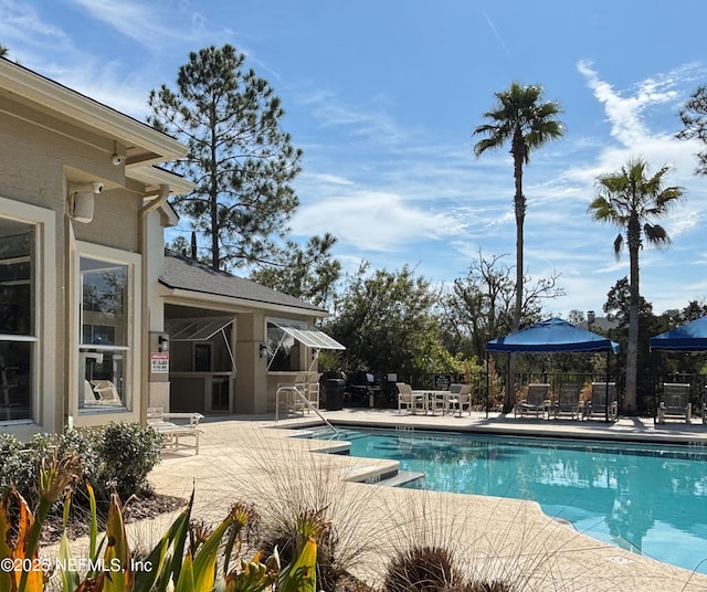 view of swimming pool featuring a patio area