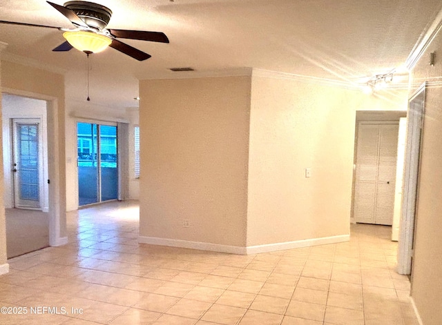 empty room featuring crown molding, ceiling fan, and light tile patterned floors