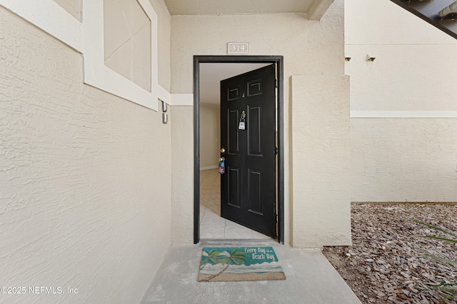 doorway to property with stucco siding