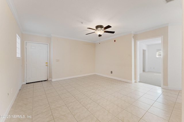 empty room featuring light tile patterned floors, visible vents, baseboards, ceiling fan, and ornamental molding