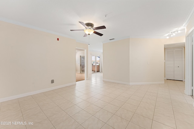 empty room featuring ornamental molding, a ceiling fan, baseboards, and light tile patterned floors