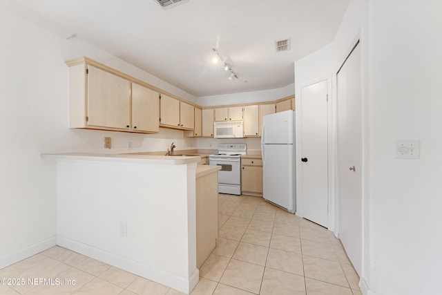 kitchen with light countertops, visible vents, a sink, white appliances, and a peninsula