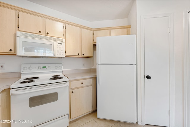 kitchen featuring white appliances, light countertops, and light tile patterned floors