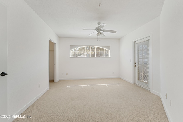 carpeted spare room featuring ceiling fan, a textured ceiling, and baseboards