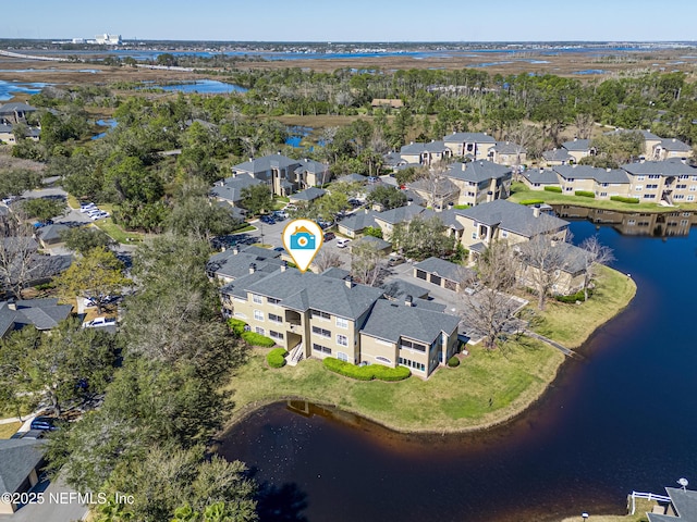 drone / aerial view featuring a water view and a residential view