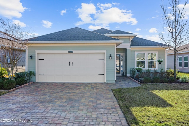 view of front of property featuring a garage and a front lawn