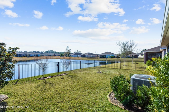 view of yard with central AC unit and a water view