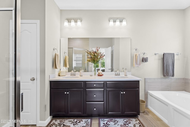 bathroom with vanity and separate shower and tub