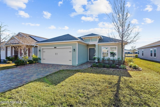 view of front of home featuring a garage and a front lawn