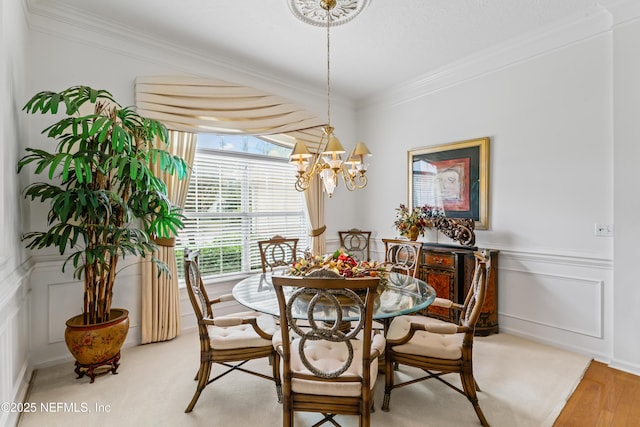 dining room featuring a chandelier, crown molding, and hardwood / wood-style floors