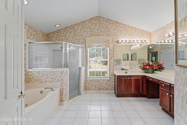 bathroom featuring shower with separate bathtub, vaulted ceiling, and vanity