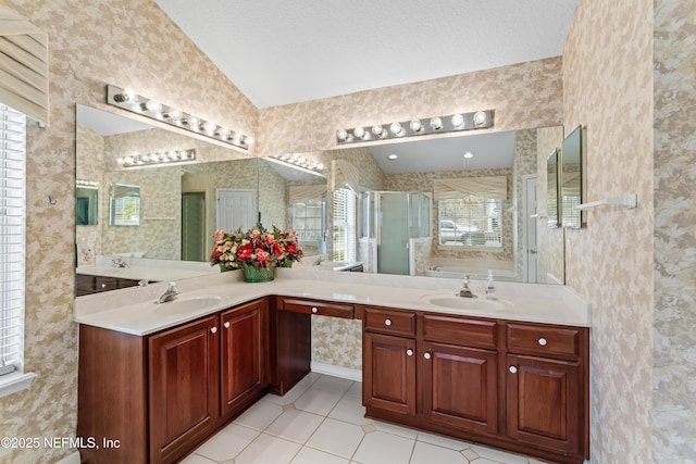 bathroom with tile patterned floors, vaulted ceiling, independent shower and bath, and vanity