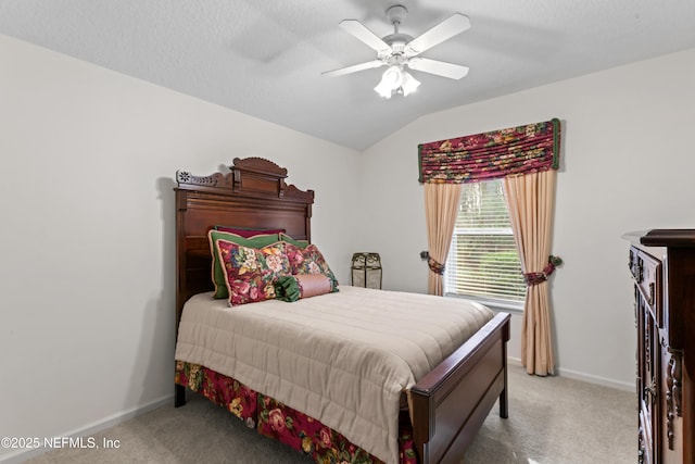 bedroom featuring a textured ceiling, lofted ceiling, carpet flooring, and ceiling fan