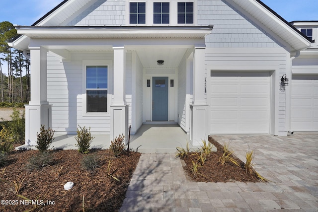 property entrance with a garage and covered porch