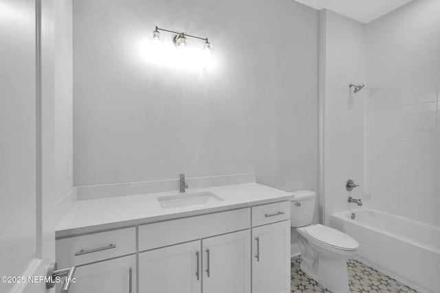 full bathroom with vanity, tiled shower / bath, and toilet