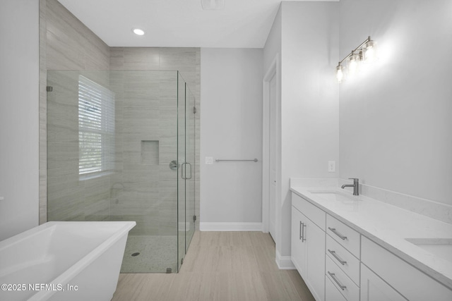 bathroom featuring vanity and separate shower and tub