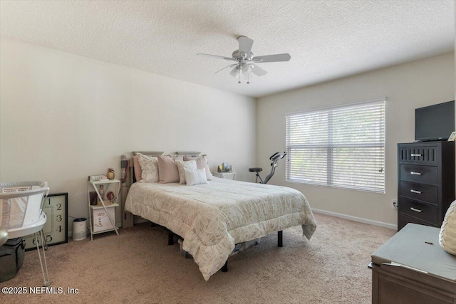 bedroom featuring ceiling fan, light colored carpet, and a textured ceiling