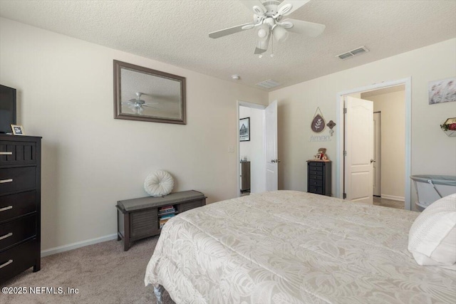 carpeted bedroom featuring ceiling fan and a textured ceiling