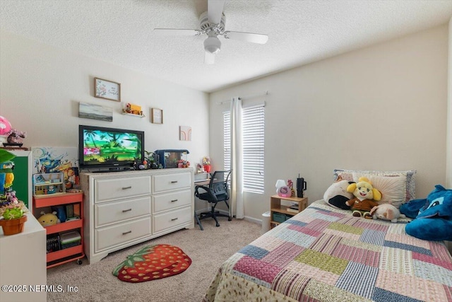 carpeted bedroom featuring ceiling fan and a textured ceiling