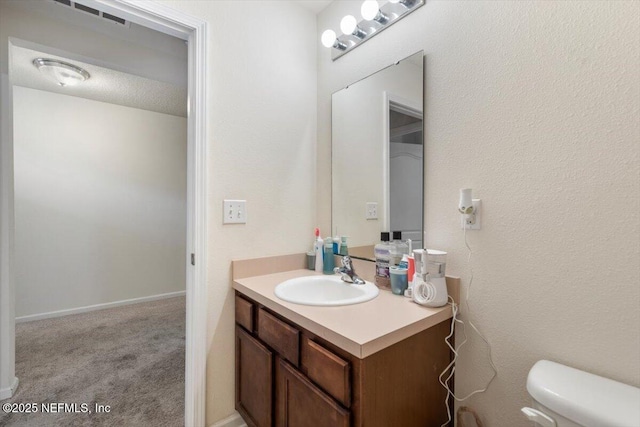 bathroom with vanity and toilet